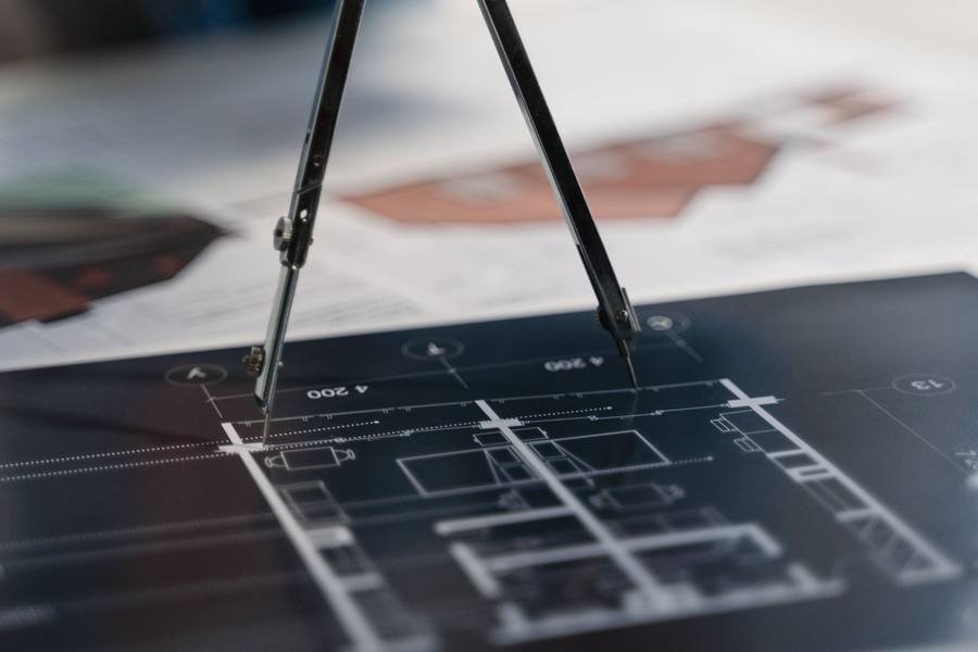 A compass over a technical drawing.